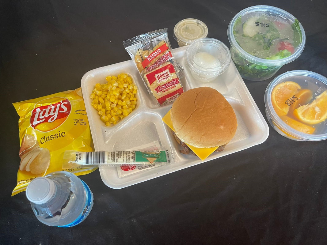 Picture of box lunch for 2020 school year. meatballs, fruit salad, green salad, and water
